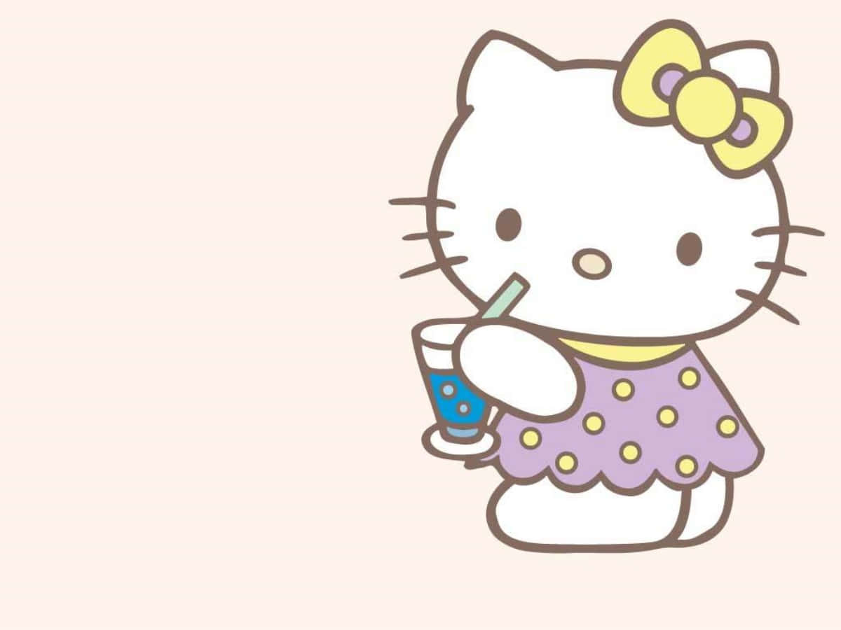 Hello Kitty در حال نوشیدن نوشیدنی روی لپ‌تاپ والپیپر